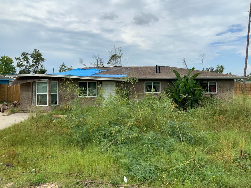 This 3/2 can be restored to what it once was.  Home still damaged, some trusses are broken, but all trees have been removed.   Has not had drywall removed.   Check it out but use caution.  Some mold.  Refrigerator has NOT been cleaned out.  PLEASE do NOT open.   Super convenient location close to everything on 23rd St. and 98.