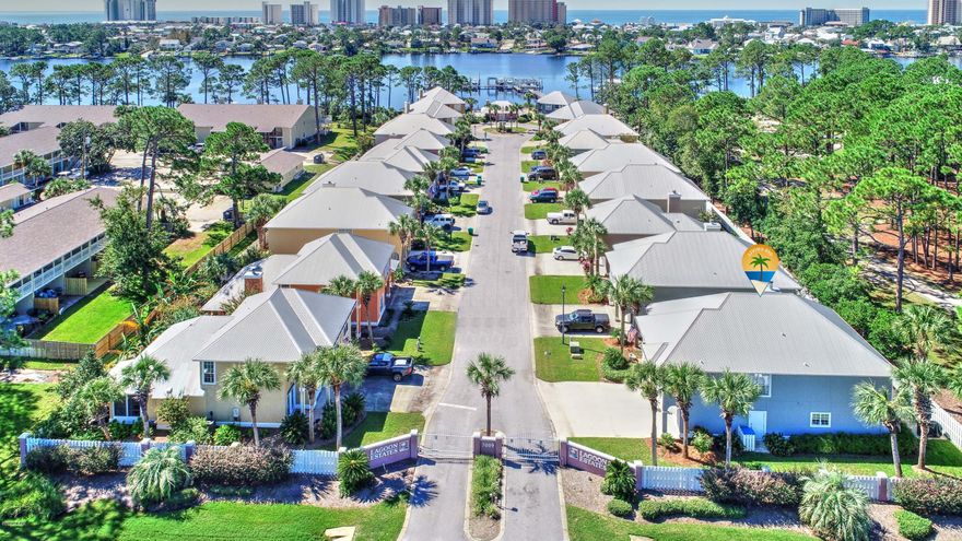 ACTIVE CONTINGENT. TAKING BACK UPOFFERS. BOAT SLIP WITH A LIFT ON THE LAGOON.This is a beautiful home in a gated community on North Lagoon. Just steps to the Lagoon. Boat slip is assigned to your home for your use only. Slip will accommodate a 24 foot boat. Well maintained home and never rented, second home only. New brick patio, screened in back porch.  House is being sold furnished with a few exceptions of items they are taking. Sprinkler system, All tile and hardwood flooring. 2 AC units and tankless gas hot water heater.  This home has a bigger yard because it is an end unit.  Community pool and dock for fishing and boating.  You will not find a better home on the Lagoon for the price. All measurements approximate.  Please measure if important.