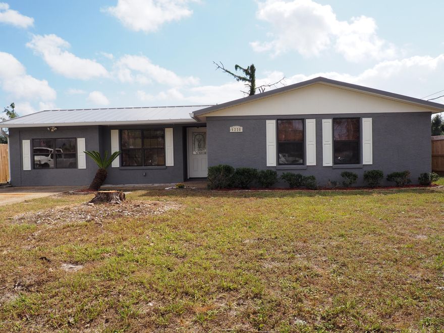 Beautifully updated home that is move in ready. The first thing you notice as you drive up is the two beautiful palm trees and large landscaped front yard. As you walk through the front door you are greeted with a beautifully tiled open floor plan living room, dining room, and kitchen. The, custom built, white kitchen cabinets and new stainless steel appliances jump out at you. The warm freshly painted walls will match any home and furniture décor. Master bedroom is a lovely getaway with new vinyl plank flooring, ceiling fan, and 2 closet storage spaces. The master bedroom also has it's own totally renovated bathroom with a full tub/shower to relax in after a long day. Step through the French doors onto the large patio perfect for BBQ's and outside parties. The large privacy fenced back yard provides security for you, children or pets. Store all your lawn equipment, out of season decorations and extras stuff in the new storage building on a concrete slab. The utility room has plenty of space for your washer, dryer, storage and a pantry. New metal roof installed last year will last longer than normal shingles. Appreciate a comfortable room temperature throughout the house with the newer high efficiency air conditioner and ceiling fans. With today's low interest rates and the new Hurricane Michael relief fund now is the best time to buy ever. Contact your favorite Real Estate agent today to see this unbelievable home.