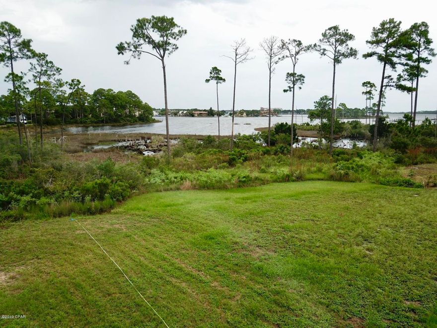 Build your dream home on one of the last waterfront lots in Bay Point. This large lot is located on a cul-de-sac and offers beautiful views of Grand Lagoon. This lot is mostly cleared and ready to build on. Bay Point offers its residence the safety of a gated community, tennis, golf, restaurants and Serenity Spa all located a golf cart ride away.