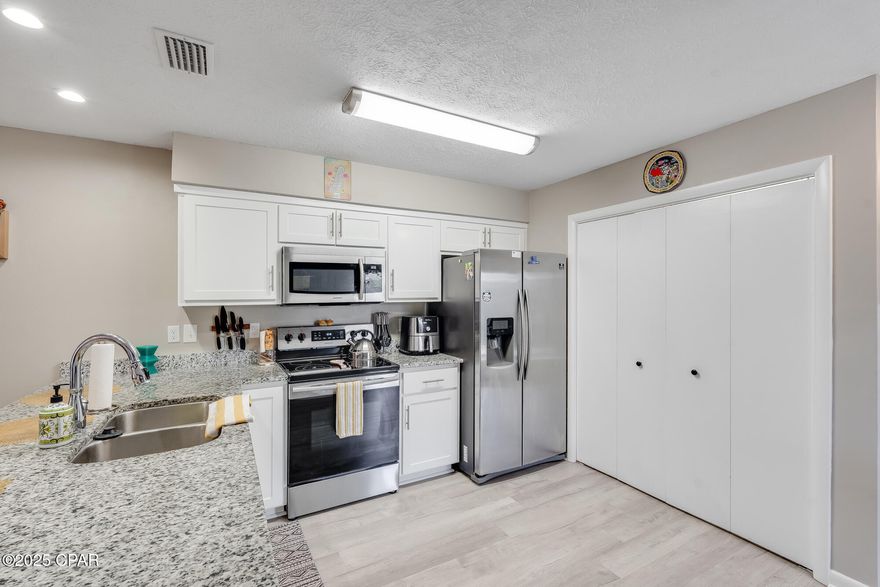 Currently under contract, seller will consider backup offers. Welcome to 2026 Baker Court, Unit 24, a prime location end unit in the highly coveted Baker Court Townhome neighborhood of Panama City, Florida. This immaculate end unit townhome was completely remodeled in 2019.  Spanning 1,232 square feet, this 2-bedroom, 2.5-bathroom residence boasts a thoughtfully designed layout that maximizes comfort and functionality. Upon entry, you're greeted by an inviting living space featuring vaulted ceilings, creating an airy ambiance filled with natural light. The main level presents an open kitchen, dining, and living area, ideal for both daily living and entertaining. The primary bedroom, complete with an en-suite bathroom, is also conveniently located on the first floor and features a bay window with bench seating.  Stepping outside, you'll discover a delightful back patio enveloped by mature trees, offering a serene retreat for outdoor gatherings or moments of quiet reflection. On the second floor,  you'll find a second bedroom with its own en-suite bathroom, providing comfort and convenience for guests or family members. Additionally, a half bath is conveniently situated downstairs. This townhome also features a laundry closet located on the main level.  Nestled in the peaceful Baker Court neighborhood, this residence offers a serene retreat just a block away from Beach Drive and Saint Andrews Bay. Residents will appreciate the proximity to both St. Andrews and downtown Panama City, bustling with unique local shopping and dining establishments. Centrally positioned between Tyndall Air Force Base, the Navy Base, and the Coast Guard Station, as well as Panama City Beach, this location offers easy access to a variety of amenities and recreational opportunities. 
Roof 2019, HVAC 2019, 

All measurements ar approximate and should be verified by buyer if important.