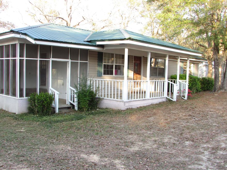 Cute 3 Bedroom 1 Bath home with 1403 sq ft located on a 1 acre lot!  Relax on the screen porch, front porch or back porch! The home has wood floors in the living area. The kitchen has lots of cabinet space with breakfast bar! Located 1 mile from I-10, Shopping, Dining , Schools and Hospital. This home is price to SELL so call today for more information!