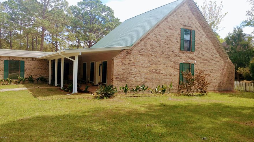 You will feel at home as soon as you will arrive in the huge circle driveway of this 2 car garage great home.From Roof, electric, plumbing, AC/Heat System, ALL WINDOWS, floors, walls, fixtures, wood cabinets, garage, gutters, Fire place, Kitchen, new appliances, baths, laudry room, Landscape. EVERYTHING IS NEW!5 Bedrooms, 3 full baths. The master Bedroom and new master-bath with huge glass door shower are downstairs as well as a second bedroom and full bath. Open concept huge living areas are covered with new designer tiles. If you are looking for more than an acre land privacy, city water and sewer and a spacious home, NO HOA, simply a great country feel for your family at 12 minutes from town, groceries and all you need, also 23 minutes to Tyndall AFB. Here you go. Come take a look!