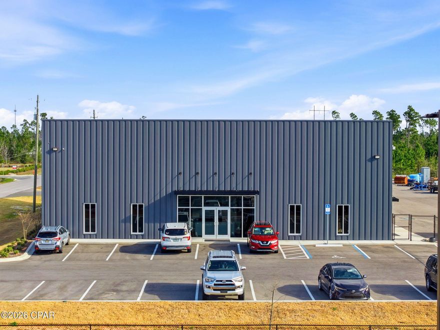 Prime commercial warehouse opportunity at 2816 Forester Trail in Panama City, FL! This impressive 16,600 sqft facility features approximately 12,000 sqft of heated and cooled office space and 4,000 sqft of open warehouse storage. The warehouse is equipped with four oversized garage doors for easy access and operations. Inside, the office space showcases beautiful LVP flooring, high ceilings, and recessed lighting throughout, along with multiple private offices, one full bath, one half bath, and a full kitchen complete with electric range, microwave, and refrigerator. Situated on a property with a large parking area and lay down yard, this versatile building is ideal for a variety of commercial or industrial uses.