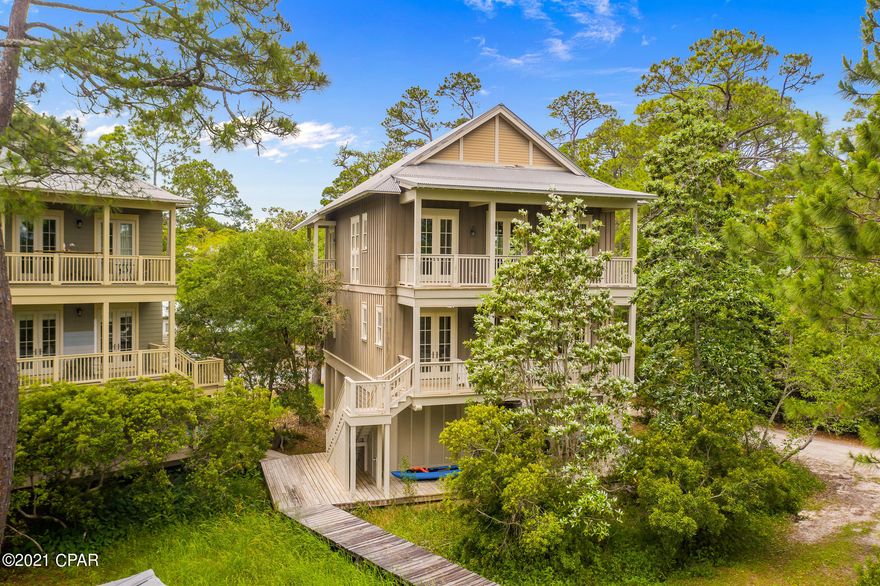 'CURRENTLY UNDER CONTRACT, SELLER ACCEPTING BACKUP OFFERS'-Stunning waterviews and dock access directly on Western Lake in beautiful Grayton Beach with no HOA fees. This custom craftsman style home was designed by architect Geoff Chick in 2006 and is nestled on a private road with mature trees in the heart of Grayton Beach. Authentic heart of pine floors flow throughout the open floor plan and an abundance of French doors and windows, optimize the majestic Western Lake views from the living room, kitchen and dining area. The master bedroom has a private balcony overlooking the lake and dock, gorgeous pine beams serve as crown molding, large walk-in closet and private bathroom with double vanity and spacious walk in shower. Down the hall are 2 additional bedrooms with en-suite baths. The second floor has 2 bedrooms and one can easily be converted to a bunk room to maximize rental potential.  The kitchen features quartz countertops, stainless steel appliances and a large island to enjoy your meals and share stories with your friends and family. This home is perfect as a primary,, second or vacation rental. Don't miss this opportunity to have Western lake in your backyard. You can launch your kayaks, paddleboards and fish just steps from your backdoor. Wake up to a gorgeous sunrise at "Grayton Sunrise."