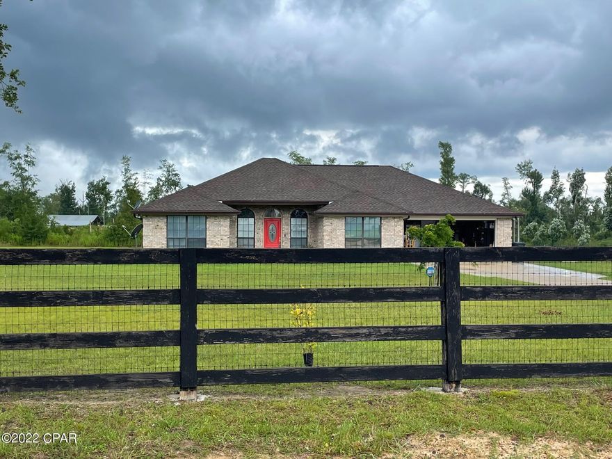'CURRENTLY UNDER CONTRACT, SELLER WILL CONSIDER BACKUP OFFERS Looking for a nice home with acreage and room for horses? This wonderful 3 bedroom 2 bath all brick custom built home is situated on 3.77 acres offering privacy and country living just 22 miles from area beaches. With almost 2300 square feet, this recently painted home has a split floor plan with 10'-12' ceilings, a spacious kitchen and breakfast nook, separate formal dining room and large living room with wood burning fireplace.  Pride of ownership and upkeep shows with new roof (2022), Rheem 50 gallon water heater (2019), HVAC  with UV germicidal system and I wave purifier  (2021), double Whirlpool oven (2020) and Microwave (2021). Seller recently invested in new SunPro solar panels (2022) plus a $20K backup power storage batt seamless low energy costs This home is also on well water, sourced from the largest aquifer in the area. Exterior features include Pole Barn slab and frame structure with electric and water access, perfect for an RV.  160 Sq Ft work shed also has power and tons of tool storage. 700 sq foot 2 stall horse barn has a new roof. Other features include real oak cabinets and huge pantry in the kitchen. Master bedroom has French Doors that open to patio and 16x8 HUGE walk in closet. Master bath has whirlpool tub and separate shower with his/her vanities. Both bathrooms flooring recently installed LVP. Custom solar reflective Bali blinds and tinted windows are additional features. Garage door is highest wind rating available. Thomas Road is a quiet dirt paved road and is tucked away just 19 miles from Tyndall AFB, minutes from shopping, hospitals, restaurants and so much more. Call for your private showing today. All ages, sizes including sq. ft. are approximate. Please measure if important. 'CURRENTLY UNDER CONTRACT, SELLER WILL CONSIDER BACKUP OFFERS