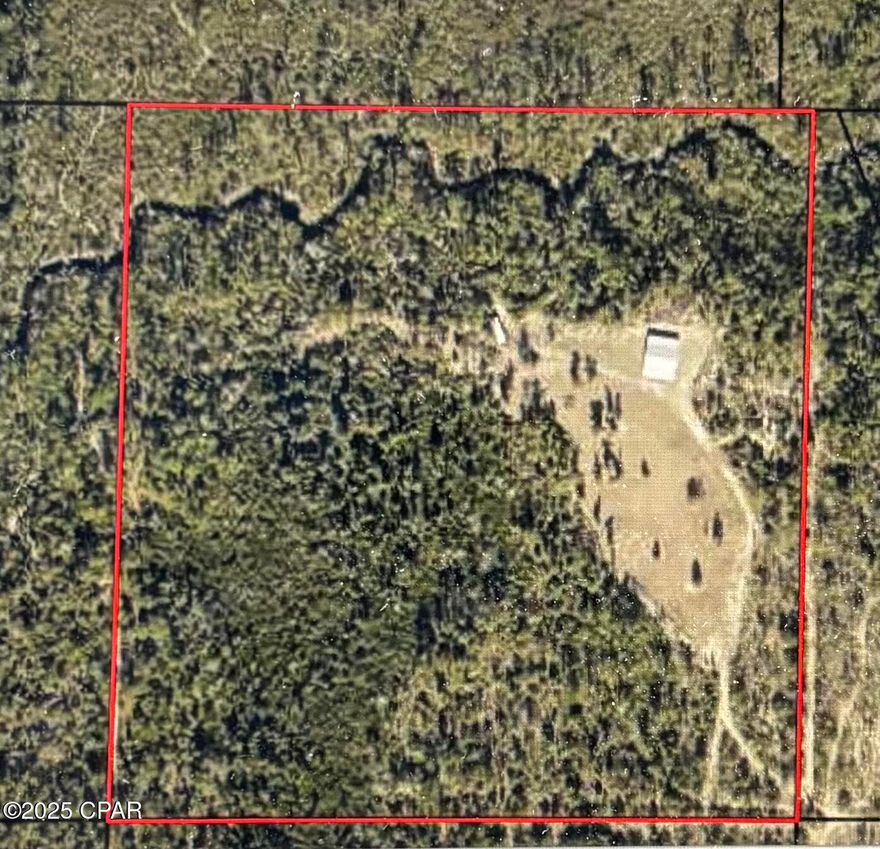 40 acres of developable land with a 36X60 enclosed building. Well and septic on land, and a new Holland back hoe comes with the sale.