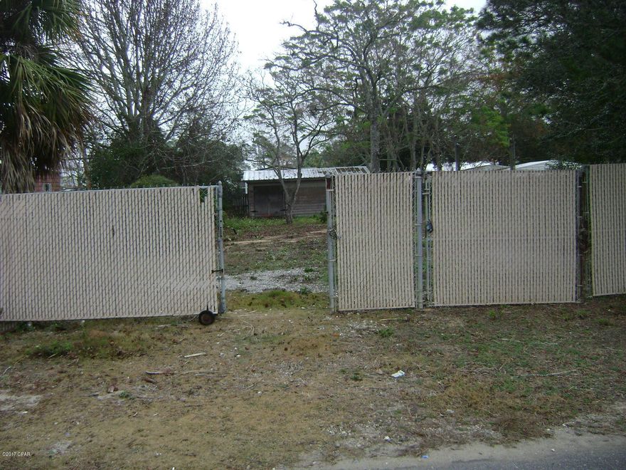 Great lot with electric, water and sewer already on lot.  Across street from Holiday Golf Course, just minutes from Pier Park Mall with shopping,restaurants and entertainment.  Large storage building on lot.