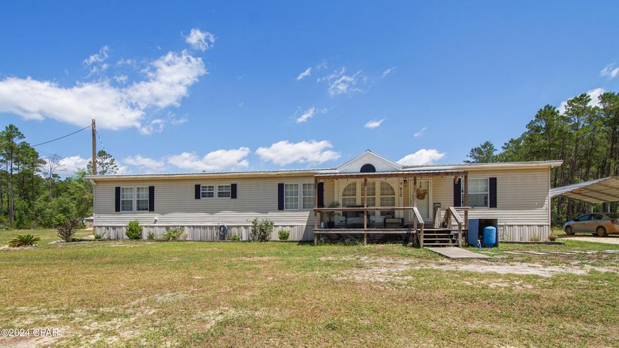 Escape to this quiet, peaceful countryside retreat with this exceptionally spacious 4 bedroom 2 bathroom 2008 double-wide Clayton manufactured home, nestled on 3 acres of meticulously cleared land - a blank canvas awaiting your personal touch. Step inside to discover luxurious LVP flooring flowing seamlessly through the kitchen, dining area, and den, creating a sense of cohesion and elegance.

The heart of the home is undoubtedly the kitchen, a culinary haven boasting an abundance of cabinetry, offering ample storage for all your cooking essentials. Newly installed countertops and a large basin sink add a touch of modern sophistication, making meal preparation a true joy.

Unwind in the inviting living room, the main gathering space where cherished memories will be created, or retreat to the cozy den, complete with a warm and inviting fireplace, perfect for those chilly evenings. With 4 bedrooms, this home offers ample space for growing families or accommodating guests in utmost comfort. But wait.... the surprises don't end there - a bonus room awaits, ready to be transformed into your personal haven, whether a home office, gym, or playroom.

Venture outside, and you'll find a world of endless possibilities. The property has been expertly cleared, allowing you to bring your dreams to life - build your dream home, establish a small farm, or simply bask in the serenity of wide-open spaces. Gather around the fire pit area, where laughter and stories will fill the air, with family and friends.  There is also a custom built kennel in the backyard, perfect for your furry companions, to keep them shaded, and safe from harm.

This remarkable home has been meticulously updated, boasting a new metal roof installed in 2022 and a brand-new HVAC system in 2023, ensuring your comfort and peace of mind. Relax on the newly constructed 14x32 covered back porch, embracing the gentle breezes and taking in the expansive natural surroundings.

With its generous dimensions of 189x737x189x734, this property offers ample room to grow and breathe. Zoned R-2, it even provides the opportunity to divide the land and add a second address, perfect for a mother-in-law suite, tiny home, or even a rental income opportunity.

Conveniently situated on a county-maintained dirt road, this property offers the perfect balance of seclusion and accessibility. Don't miss your chance to make this extraordinary country home your own personal paradise. Schedule a viewing today and embrace the tranquility and freedom that await you.