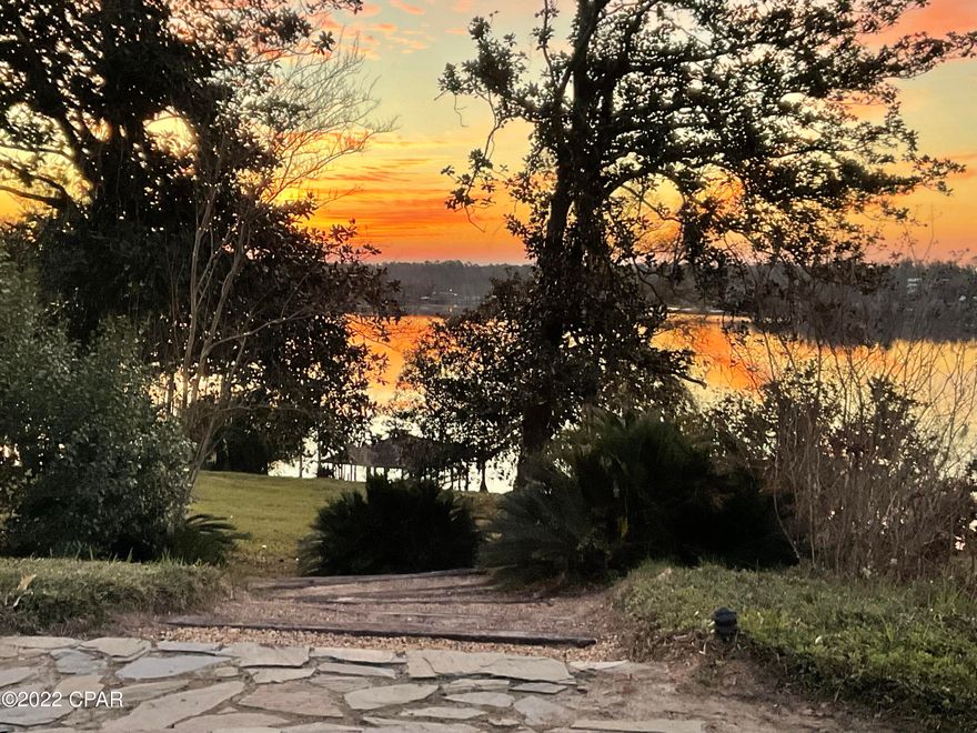 Welcome to one of the most beautiful lakefront properties in North Florida. Resting on crystal clear Compass Lake, this one-of-a-kind 5+ acre property offers you the best of all worlds- the peaceful privacy of an inviting all-natural landscape, swimming, boating and fishing in one of Florida's cleanest spring-fed sandy bottom lakes.  The property has  extensive private beachfront (over 500 feet) existing docks, a boathouse, a 2-car garage, a 1 Bedroom, 1 bath apartment as well as carport.  The property could be subdivided or be a beautiful large building lot for new construction.