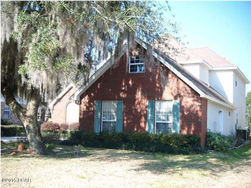 Brick and stucco home located on the 5th green of Panama Country Club which offers private championship golf, bay front clubhouse, and pool...Interior of home offers tiled living room with fireplace, formal dining room with laminate wood flooring, kitchen with custom cabinets and gas stove, breakfast room, downstairs master bedroom, half bath, and three bedrooms (one bedroom would make great play room/media room, it measures and one bath upstairs...Exterior offers side entrance two car garage, open patio, large oak tree, sprinkler system, and great views of the course... All sizes are approximate, please measure and verify if important. School assignments are subject to change, please check with Bay County for most accurate information.
