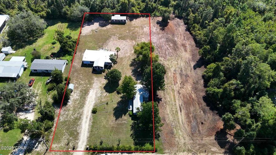 Two MHs + cottage on ~1 acre (AS-IS).
Recently cleared, level homesite offering multiple options: rehab, remove/replace with a new manufactured home, or build new. Property includes two mobile homes plus a shed-to-mother-in-law cottage. One MH shows tile/LVP flooring, vaulted living area with fireplace, and covered porch/deck; the second MH is largely demoed to studs; the cottage has a kitchenette and bath started. Quiet country setting with room for parking, trailers, or future outbuildings and easy access to Hwy 231/Panama City.

Not turnkey. Sold AS-IS. Seller will make no repairs. Cash or renovation financing only. Buyers to verify all measurements, age/condition, utilities, zoning/use, and feasibility for bringing in or building a new home. Use caution during showings.