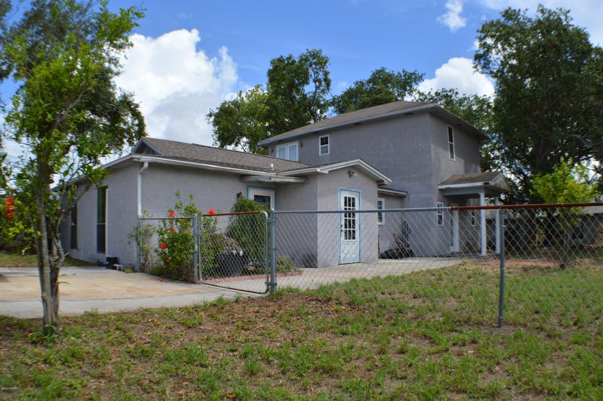 An awesome opportunity awaits you with this sweet deal!!  The purchase price actually includes the lot next door (a $125000 value!) where you can keep for extra land or parcel off for development.  This home is setup perfectly as a 3/3 for short or long term rentals or even sublet as the home is designed to have two living spaces!  There is plumbing and setup built in the wall in the main Living Room under the two-story structure.  The home can be divided like a duplex with a 2/2 in the front and a two-story structure in the back with minimum work to be ready for prime time!  The Master Bedroom and Bath are extremely spacious.  The walk-in closet has more than enough room and there's even a covered patio out back!  Bonus - Golf cart parking on the side and 5 minutes you're on the beach!!!!