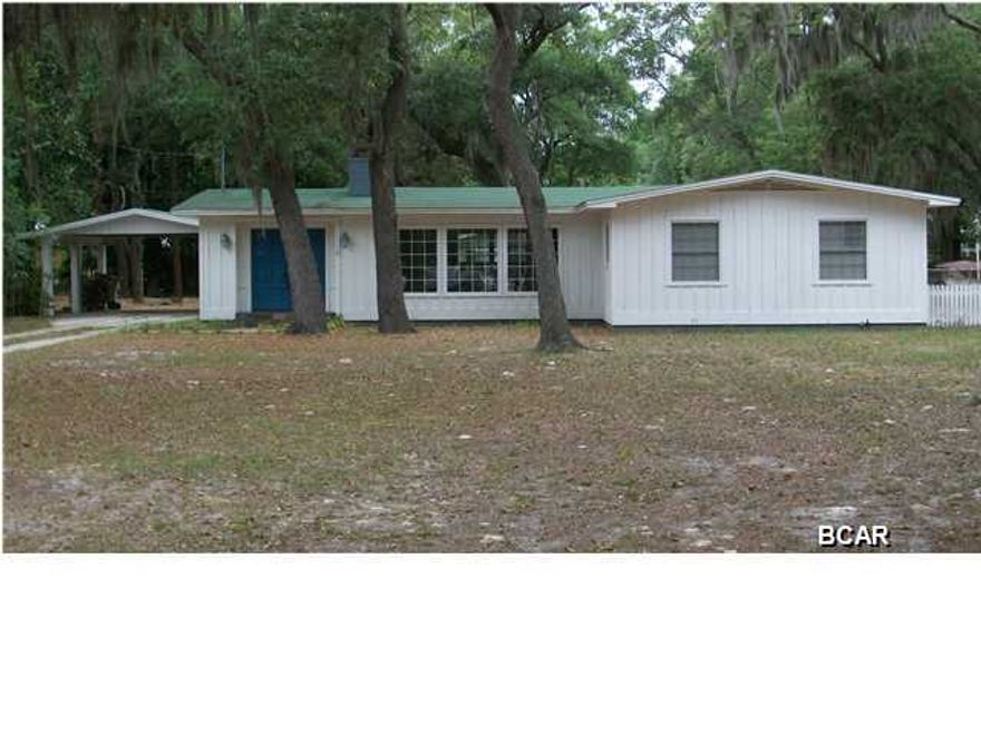 You really have to see this charming home to appreciate it. It was originally built in 1966 but the previous owner completely renovated the inside so the effective age is 2005. Lets start with the location which is in Donalson Point and is 5-minutes to Tyndall Air Force Base. This house sits on a large lot which is almost 1-Acre. It has front to back driving access from Parkway Dr through the entire lot to the rear service road. Large live oaks provide plenty of shade and there is a nice waterview across the street of Pitts Bayou. The front entrance has a set of double doors and three large ''Pella'' windows that let in lots of natural light. Exposed ceiling beams along with some original ''Heart Pine'' ceilings help highlight the custom stone fireplace. The main house right now