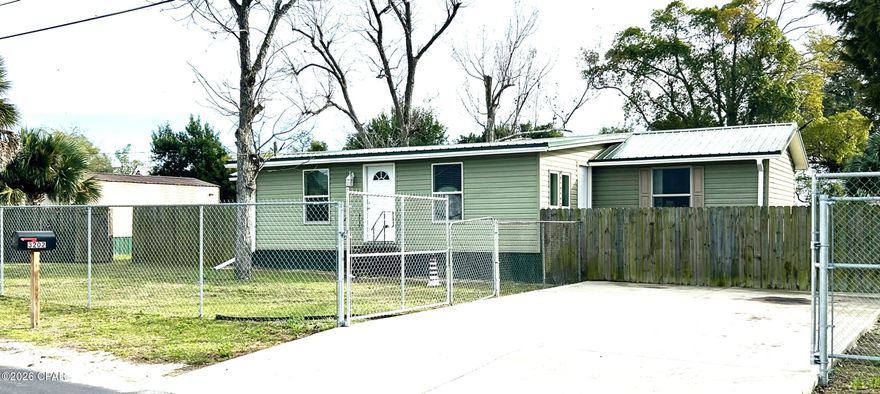 Welcome to your happy place.  As you pull into one of your paved parking spaces you are greeted by Palm and Pecan trees in your fully fenced 1/3 acre yard. As you open the door you enter into your newly remodeled home, the living area has a warm beachy feel. This cozy nest, opens into to the kitchen dining area with freshly painted cabinets, new flooring, and enough room for a huge kitchen table. On opposite ends there are bedrooms with their own bathrooms! Your stainless convection oven with built in air fryer, matching microwave and side by side refrigerator with ice and water in the door  make cooking a breeze. Out the back door is a covered patio/carport area and a 12x20 storage shed. Your huge back yard boasts two more Pecan trees and even more palm trees! There is also another 12x28 building, that we call the cabin, that can be used for even more storage, a guest house or even a possible rental. The Cabin has a shower and kitchen area, hot water heater, and electricity. What more can you ask for? Nice move-in ready home, new paint and flooring throughout, paved parking spaces. tons of extra parking for toys, big fenced yard, storage shed, covered carport/patio, and a possible rental, it's all here. All for an affordable price. You gotta see this one.