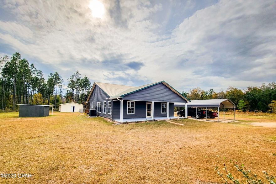 Welcome to country living!  1931 Cutchins Rd. offers the best of peace and privacy.  Located on a cleared 1 acre lot with plenty of room to play, relax, or expand.  Only an 8 minute drive to Cottondale, and 12 minutes to Chipley.  This amazing ranch style home features 3 bedrooms on a split floor plan, and 2 full bathrooms.  Once you pass through the covered porch, expanding the entire width of the home, you enter into the open concept living, dining, and kitchen layout.  The stained wood trim, wood floors, and custom built wood barn doors enhance the warmth throughout the home.  The kitchen features granite counters, 42'' cabinets, stainless steel appliances, and a custom built island that is movable to your liking.  Behind the custom built barn door is a large pantry/storage closet.  The large master bath features granite, a new tiled shower, tile floors, and the enormous master closet.  Off the living room are the two large guest bedrooms, and the second full bath, again with matching granite.  The large laundry room includes a laundry sink, side by side washer and dryer (included), and the attic access.  Up the new aluminum pull down stairs, the attic features a bonus space large enough to finish a bonus room, and has blown in foam insulation throughout.  Off the kitchen is the tranquil screened-in porch.  

On the exterior, the entire home, with hardie board siding, was repainted less than 2 years ago.  The metal roof just completed a thorough inspection, and was retightened  The HVAC system was replaced 1 year ago with a brand new unit, including the 5 ton air conditioning unit!  The back yard has a large area fenced in, and includes the large 24'x24' workshop.  The workshop has a brand new roof, and could easily be converted into a detached 2-car garage with the addition of garage doors.  There is also an open shed east of the house that protects the well and pump equipment.  The septic system is the more costly above ground, or ''mound'' septic located to the right of the home.  

You can experience the best of the Florida panhandle with a short drive in any direction.   The home is located within 20 miles to Falling Waters State Park, approximately 10 miles to Florida Caverns State Park, close to Interstate 10, 24 miles to Cypress Springs, and about an hour drive to Florida's most beautiful beaches!  With the perfect amount of seclusion, yet the close proximity to an array of attractions, 1931 Cutchins Rd. truly has everything to offer.  Contact me today to schedule a showing before it's too late!