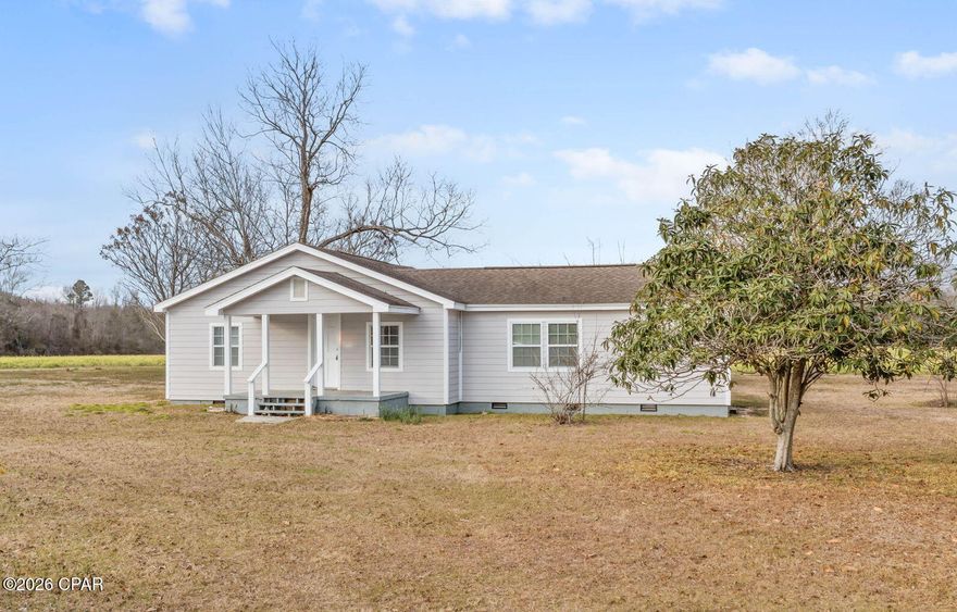 Welcome to this charming 3 bedroom, 2 bath farmhouse-style home situated on 5 peaceful acres at the end of a quiet road, offering privacy and scenic views of open fields. Step inside to find beautifully stained hardwood floors and a split floor plan designed for comfort and functionality. The spacious primary suite features an en suite bath and a walk-in closet, providing a private and relaxing retreat. Surrounded by wide-open land and tranquil countryside, this property is ideal for those seeking a slower pace and room to enjoy outdoor living. Whether you're looking for a full-time residence or a quiet country getaway, this inviting farmhouse offers the space, setting, and charm to make it your own.