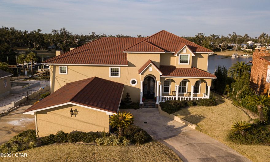 1309 Bayou Court located on the best DEEP Waterfront available. Features to notice - boathouse w/ lift, 5 beds, 4.5 baths, 5510 square feet, drive through garages, .64 acres, in-ground pool, updated top to bottom, this house checks all the boxes! The home is set back over 100 feet from the road for added privacy w/ 2 drive-through garages and an extended front porch. Kitchen has been updated, Travertine floors, quartz counters, new appliances, Sub Zero fridge, Wolfe appliances, over-sized breakfast nook w/ adjoining formal dining. A spacious family room w/ fireplace, access to the backyard, pool w/ hot tub and patio as well as a boat dock. Huge Master suite set on its own level with private balcony, stunning water views, a private fireplace and unbelievable closet. Master bath, double vanity, custom cabinets, enormous tub, separate shower w/ 6 heads plus a rain shower. Simply put, the bathroom is out of a magazine. 4 of the 5 bedrooms have private water views as well as their own full bathrooms. All bathrooms have been fully updated and it shows. The backyard features, covered and open patios, a paver pool deck, private boathouse for plenty of fun in the sun! The Cove is by far the best waterfront available in this area and is also golf cart friendly and features the St Andrews Bay Yacht Club. A waterfront house, fully updated, meticulously kept, not a thing to do other than move in. A house like this is an opportunity. Come tour today!