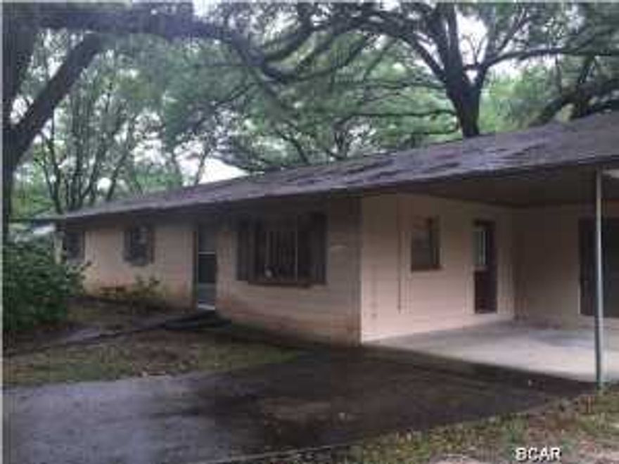 Charming block home in the country located on nearly an acre of land! This brick home has a carport with a laundry room and storage unit. The large kitchen has plenty of cabinet space and is open to the dining area. The home has a very solid feel to it is lushly landscaped with magnolia trees has plenty of parking available.