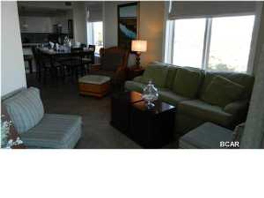 Fantastic view from this 3BR/3Bath condo that overlooks the Gulf and back towards St. Andrews. This condo is nicely furnished along with a mirrored wall along the dining area that really opens it up.