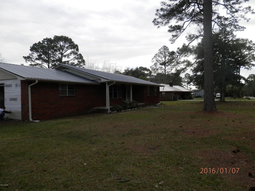 Newly remodeled brick home with fresh interior and exterior paint, single car over sized garage with lots of storage space. Located on a nice size corner lot, almost 1/2 acre. Block detached building in back. There is new flooring throughout the home with carpet in the bedrooms and living room, laminate wood floors in the kitchen, dining room and halls as well as the mud room leading out to the garage from the kitchen area. Large tiles laundry room just past the kitchen. Kitchen cabinets are refinished and new counter tops as well as tile back splash. Bathrooms are tiled. The home has a new metal roof as well as the 20x23 detached block building. just off the dining room is a large covered porch great for BBQ'S.