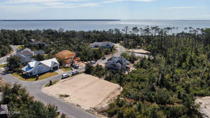 Live the Florida Lifestyle in the gated community of Sanctuary Beach; private and secluded yet close to PCB Marinas, Golf, Tennis, The Navy Base and the World's Most Beautiful Beaches! Splash in the community pool which is located across the street but secluded or enjoy kayaking on the bay - The trail to the bay is located outside the gate!

This lot has been cleared, filled and ready to build your dream home! Set backs: 25ft front, 10ft sides, 10ft rear. Single Family - No Short Term Rentals - Build to Suit available.
