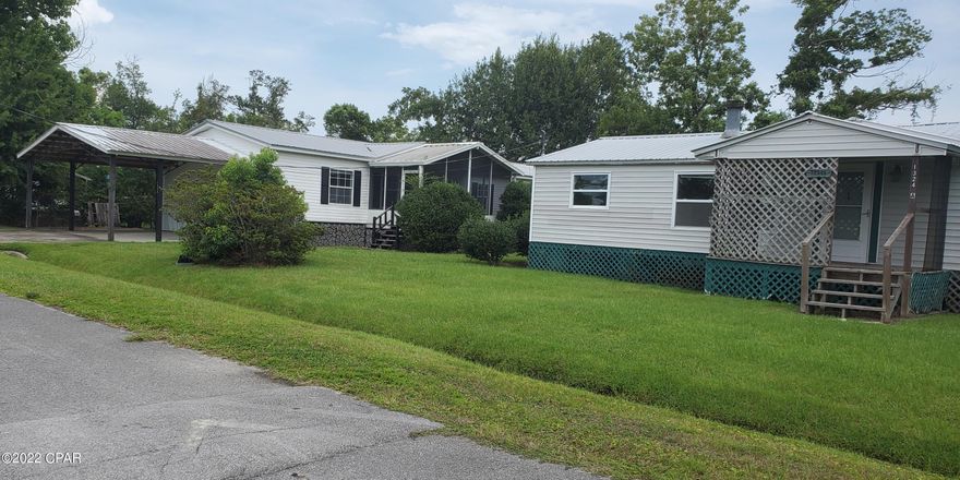 Investors Special!! Two homes for the price of one on a large  lot!

This is a great home for rental income or a mother-in-law's quarters. This property features a 3 bedroom 2 bath, 1344 sq ft manufactured main home with a full carport and screened in great room. This home has a great open kitchen and a beautifully upgraded master bath! New floors have been installed partially throughout the home. Some cosmetic work needed.

The second home is a 3 bedroom, 2 bath manufactured home which has been permanently set and is deemed real property. Some repairs on the roof on back of house needed as well as some cosmetic work. There are 2 power poles and 2 water meters on the property. Both homes have great potential!

This home is centrally located in Panama City with everything you need nearby!