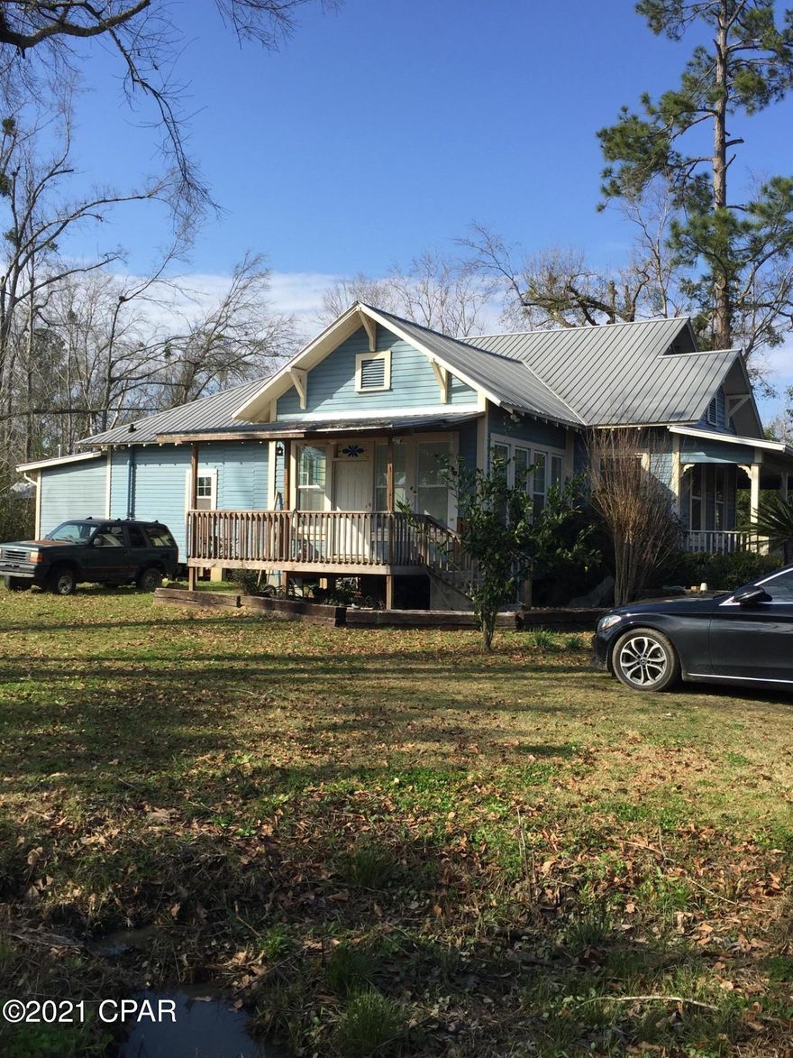 $88,000. This is a whole lot of house for the price!  Home has a recent metal roof. Located in the city limits of Blountstown, within walking distance of grocery store, post office, schools, doctors, and more!  Current owner has done some work to the home in the past year, including some electrical updates, paint, and general sprucing up.  However, there are still some items that haven't been finished but the owner is relocating and therefore is selling the home ''as is''. Kitchen is functional, but not completely finished; open front cabinets and unfinished ceiling, plus a large storage closet with washer/dryer hook-up and plenty of space for more cabinets/shelving. Gas stove stays, but refrigerator doesn't stay. Originally built in 1924, this charming home has 12-foot ceilings throughout most of the house. First level has 3 BR's, 1.5 bathrooms, kitchen, super-sized living room with dining area, sunroom, and 4.5'-wide hallway; upper level has a large music room/studio/office at the top of the stairs, then a middle sitting room with access to the upstairs bathroom, and a big 4th bedroom plus closet and attic storage space. The home needs cosmetic repairs and updates, as well as new carpet, but the seller will be moving late-February and won't be doing anymore work to the home. The city lot is 150' x 170' (.57-acre) and fronts on paved SR 69, with city water, sewer, electricity, and garbage. There is a covered side porch that is 16' x 16', back covered porch that is 10' x 20', and an irregular-shaped covered front porch that is 12' x 34' x 6' x 18' x 6' x 16'. The home has central heat and air.  If you're looking for an older home that you can work on while living there, this one may be for you! Due to some of the unfinished repairs, this home would be best suited for an FHA rehab loan or possibly a USDA loan. Seller prefers cash buyer or conventional financing.  $88,000.