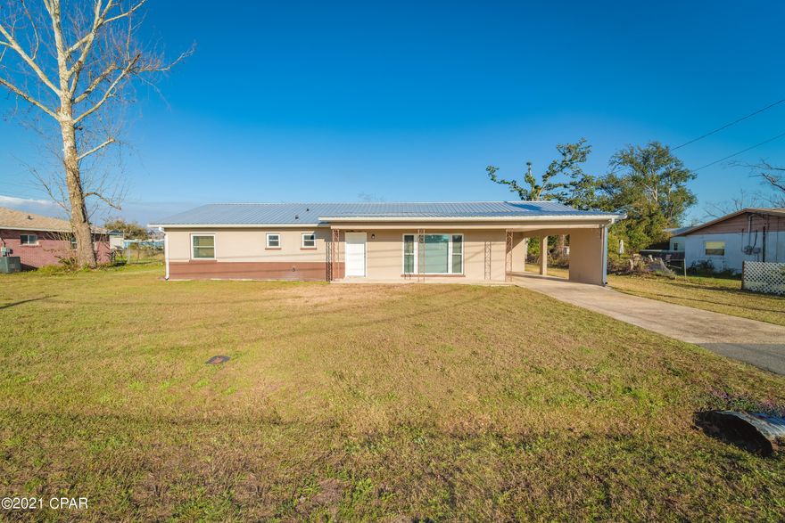 CURRENTLY UNDER CONTRACT, SELLER ACCEPTING BACKUP OFFERS. Come check out this cozy Lynn Haven home conveniently located close to shopping with highway access! Roof was replaced in 2019 with a metal roof, and the original flat roof over the carport was framed to match the pitch of the rest of the house in 2019. NEW windows were installed in 2017 in addition to NEW exterior doors and a sliding glass door being installed in 2019. All electrical lines in the home were re-wired in 2018. Call your favorite realtor today for a tour!