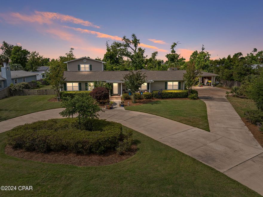 Pull into the driveway and you'll feel instantly at home. First you will notice the well manicured landscaping with a variety of plant species including 6 new live oak trees planted since 2019. Pride of ownership shows at this home both outside and inside. Recent updates to note are a remodeled kitchen, newly painted downstairs, new electrical panel, switches and new fixtures in most rooms.

Located in the ever popular Garden Club/Beach Drive area between St. Andrews and Downtown, the home is situated just one block from St. Andrews Bay where sunset strolls are a pleasure. 

This amazing remodeled, well cared for home offers 3100 square feet of living space with four bedrooms and four baths for your family.

As you enter the foyer, you immediately notice the charming hardwood floors, custom bookcases, vaulted ceilings and natural light. Windows along the front of the home are graciously appointed with classic plantation shutters, offering privacy or light as desired. 

The living room is to your left, as are a bedroom, the first bathroom, and the home office with built-in cabinets and shelves. To the right is the formal dining room with original wood floors and built-in cabinet and shelving. 

Down the hall is the second bedroom and second bath, and beyond those are the master suite. There is a large sitting area as you enter the master bedroom, multiple closets for ample storage, vaulted ceiling and traditional master bath.

The master bedroom opens to the enormous utility room/craft room/art studio with separate area for the washer and dryer. This flexible space overlooks the lush backyard and provides access to parking, garage, and workshop.

In the center of the home is the freshly remodeled kitchen with new appliances, countertops and custom tile backsplash. The kitchen overlooks the breakfast area with additional bar seating. 

Proceed through the breakfast area and you'll come to the family room, added in 1998, with a gas fireplace and built-in bookshelves. Access to a large screened porch is off the family room, again overlooking the large private backyard. 

Above the family room is a spacious fourth bedroom with en suite bath, described by guests as a quiet retreat from the world. This bedroom features a full bath with a jetted tub, vaulted ceiling, built-in bookshelves, custom window seat and storage, and ample natural light. 

The backyard is huge and fully fenced. For parking purposes there is a detached two car garage with covered walkway to the house, large carport with space for two cars, and a circular drive for additional parking. The garage also has a full workshop space in the rear for the hobbyist or mechanic. 

One year home warranty is included.