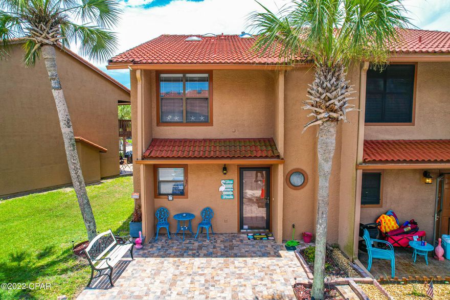 UNDER CONTRACT-SELLER TAKING BACK UP OFFERS.  Like new vacation townhome.  This unit has never been rented.  New paint inside and out.  Vinyl Plank flooring through out.  Home has a Natural Gas fireplace down stairs,  a faux fireplace in the master bedroom and  walk in showers upstairs. Beautifully furnished with top grade decor and furniture.  Stainless steel appliances and beautiful cabinets in kitchen.  Granite Counter tops. Terracotta roof and tiled patio in front. End unit with3 parking spaces. The patio in back has been expanded with tile and only steps away from the the Grand Island pool.  Gated complex, with 11 swimming pools, 4 tennis courts , shuffleboard courts and 3.2 miles of street area, for walking, or riding you golf cart.