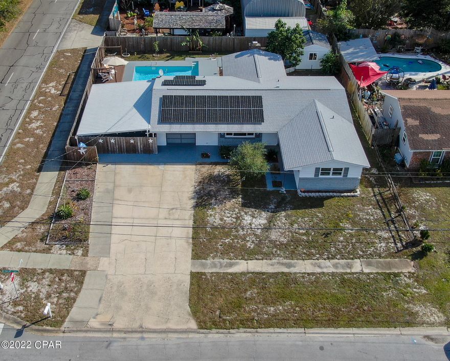 This is a charming home located in the heart of east Panama City Beach. Totally renovated and updated, this home is 5 minutes to the Navy Base, the sandy beaches, shopping and dining. 20 minutes to town or Pier Park. This 3-bedroom/2 bath has 1,710 sq. ft. of living space sitting on 0.2 of an acre. Inside you will find a renovated kitchen with newer appliances, granite countertops, porcelain tile throughout the living areas and an open floor plan. There are new hurricane proof windows in the living room and master bedroom. French doors in the recreation room lead to your outside paradise, with a newly fenced yard, a 16' x 24' pool with a replastered gunite lining, a large, covered patio and plenty of room for your grill and firepit. Plenty of storage included in the newer 12' x 12' shed. The roof is only 5 years old and the water heater less than 3 years old. Solar panels were installed last year and pay 100% of the electric costs! In 2021, the total electric bill was $190! The closing date is flexible, but March 14 is preferred, giving you plenty of time to make moving arrangements. Qualified buyers are advised to act quickly before this dream home gets away.