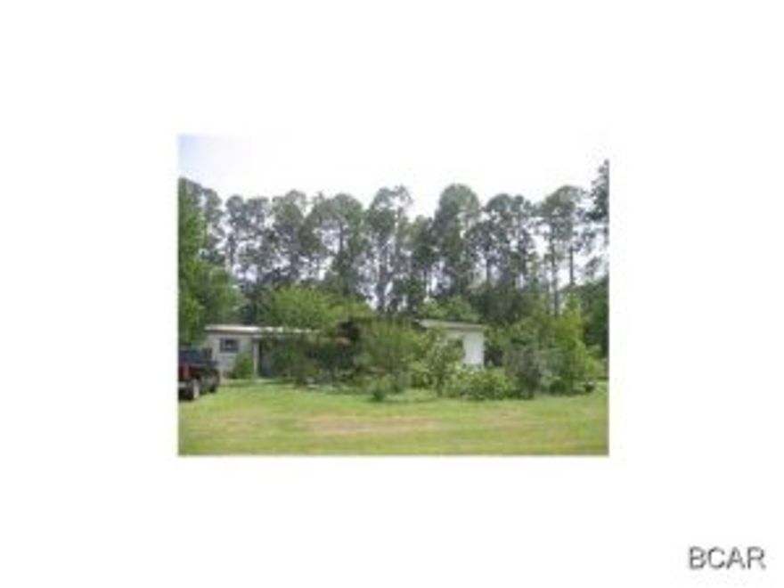 Income and investment property! This property has heavy commercial zoning which will cover almost any business you would like to operate. Great opportunity since this parcel fronts busy four lane Hwy 77. Get your offer in fast, this area is a hotspot with developers. Zoned C-3 Heavy commercial. Mobile home has no value but is presently providing rental income and could possibly serve as an office, and what a plus to have electric, water, and septic already to the lot. Property has 131 commercial footage on busy Highway 77 by 187 deep and access crossing to four lane highway. No impact fees! This area is growing and within twenty minutes of the PCB International Airport. Take advantage of this while the prices are at an all time low! Please do not approach occupant of mobile home. Call  for viewing of property. Check with Bay County water, public water is available. Great location across from Panhandle Credit Union.