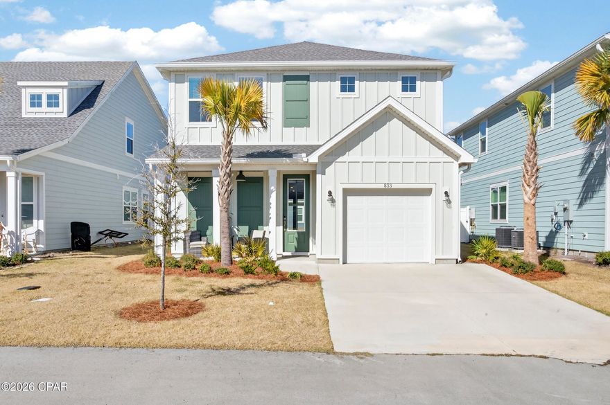 Located in Breakfast Point, one of Panama City Beach's most desirable golf cart-friendly communities, this meticulously maintained 2023 home offers modern design, privacy, and everyday convenience just minutes from the beach, Pier Park, and Frank Brown Park. Surrounded by wooded conservation land, the neighborhood feels peaceful and green, yet daily essentials - Publix, dining, shopping, top-rated schools, and services—are right outside the entrance. The owners have recently installed a Level 2 EV charger, making this home especially well-suited for today's lifestyle. 

Inside, 9-foot ceilings and an open-concept layout create a bright, connected main living space. Durable tile and engineered vinyl plank flooring span the first floor, balancing style with practicality. The kitchen anchors the home with a large island with seating, quartz countertops, stainless appliances, a farmhouse apron sink, and abundant white cabinetry, flowing seamlessly into the dining area and great room. Recessed lighting, modern fixtures, expansive windows, and 8-foot single-panel French doors fill the space with natural light and enhance the contemporary feel.

The main-level bedroom retreat offers privacy and backyard views, featuring a spacious sleeping area and a well-appointed ensuite bath with marbled tile flooring, a dual granite vanity, tiled walk-in shower, and a large walk-in closet with built-in storage. Just outside, a covered patio with a natural gas stub makes outdoor entertaining easy. 

Upstairs, kids or guests enjoy their own space with three generously sized bedrooms, a full bath with granite-topped vanity and marbled tile tub/shower, and a sunlit loft with ceiling-height accent windows - ideal for a playroom, office, or lounge.

Additional features include a tankless natural gas water heater, dual Ecobee smart thermostats, smart front door lock, dual HVAC systems, hurricane shutters, faux wood blinds, and durable board siding.

A home designed for how people actually live, in a community that makes life in Panama City Beach easy and enjoyable. Schedule a private showing and experience Breakfast Point living for yourself!