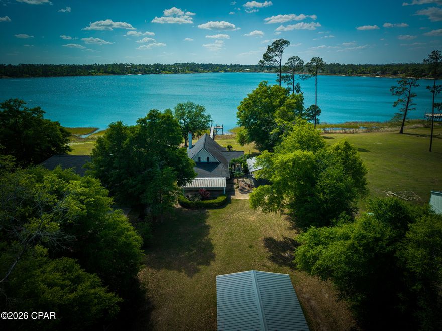 Beautiful lakefront single-family home on a full acre at the end of Seminole Lane, overlooking the pristine, spring-fed waters of Silver Lake. This 3-bed, 2-bath residence offers open living spaces, a covered porch with water views, and an entire second-story master suite for added privacy. Property features include a 2-car (20'×24') carport with an attached 20'×12' metal storage building with utilities, plus a tall 25'×12' aluminum RV-ready carport with full hook-up. Enjoy direct access to the lake from your private 82-ft dock with platform and bench, perfect for fishing, swimming, or quiet mornings on the water. Ideal as a primary residence, weekend retreat, or investment opportunity (buyer to verify rental use).