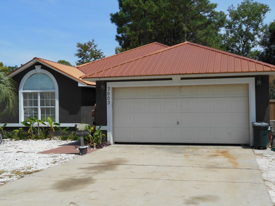 Priced below current appraisal (9/15/18). This 4 bed/ 2 bath home, comes with a beautifully furnished Guest House to rent. Both have a new metal roof as of 2017. There's a wood burning fireplace in the living room, 2 dining areas, and lots of closets for storage in the main house. The master bath has a new whirlpool tub, and glass bowl sinks in both baths. There's also a covered back porch for relaxing, and the whole back yard is privacy fenced. Finished in 2016, ''Storm's Place'' is a detached studio apt. w/ 400sf, has a private entrance, and currently rents for $225/week. Would also make a great mother in law suite. Both are a short 5 minute walk to the public boat ramp on Grand Lagoon, and a 10 minute walk to the Gulf of Mexico. Don't miss this great income opportunity. All meas. approx