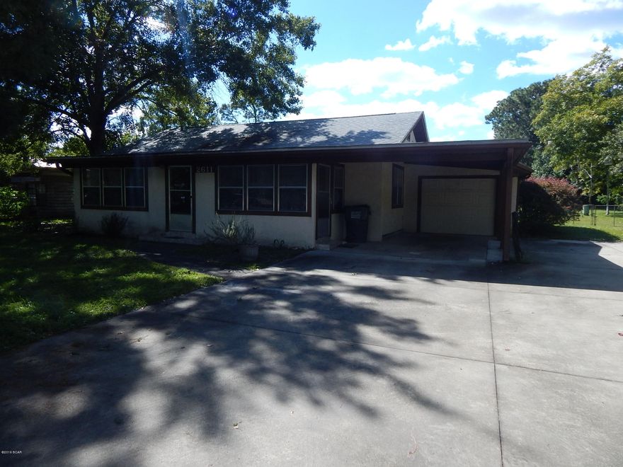 Large home sitting on almost 1/2 acre with some upgrades right off Transmitter Road.  Home features 2 large bedrooms and 1 bath.  Formal living room, dinning room and bonus room.  The kitchen has been remodeled with granite countertops, custom lighting and new cabinets.  Ceramic tiled floor throughout the new kitchen.  From the kitchen you will step down to a large Family Bonus room with built in cabinets shelves.  Home does have a deep one car garage, carpot,  oversized and extended drive parking for cars, boat, RV.  The back yard is fully fenced in.  Well Pump for irrigation.  This home is well priced and with a great floor plan.