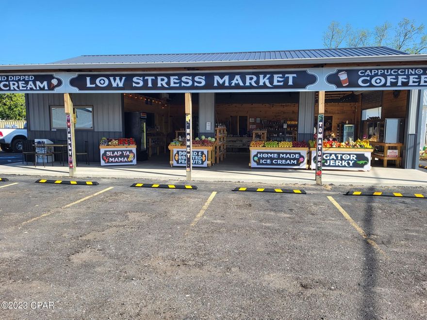 Location Location Location,  perfect  for a retail store.  Sits beside a very busy convenience store and at a major intersection Hwy 231 & Hwy 90 in Cottondale Fl.  Low Stress Country Market built this bldg in 2019 with 1500 sq ft heated and cooled.  Can be an open air market with 4 Roll up doors.  300 sq ft room can be closed off.  Comes with a large cooler. Additional equipment can be purchased separately.  High Visibility!  Comes with space for another building or park a small mobile home for extra living room or rental.   Bldg has separate ofc with private full bath and one public restroom. Paved parking. Inside fully insulated and cooled. Excellent small business opportunity to be independent and build lasting repeat business for years to come.