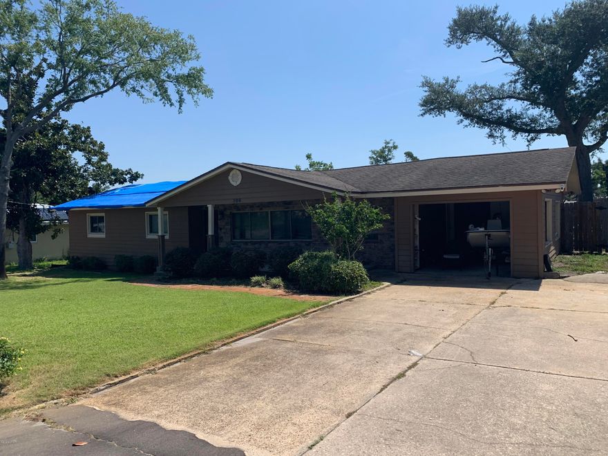 Beautifully remodeled home that suffered HURRICANE DAMAGE and needs a buyer who can make some structural repairs, but the homes many recent upgrades were largely spared from significant damage! With its location in the heart of the  HISTORIC COVE area this would make an excellent opportunity for an investor Rehab.   lots of charm and modern upgrades, and on a double lot!!! The kitchen has CUSTOM WOOD CABINETRY with Corian counter tops and stainless appliances. A spacious Living Area offers lots of flexible living space. The Master Bedroom features a an adjoining space that would make a wonderful private office or Nursery. Loads of outdoor living space on this DOUBLE LOT that includes a huge covered back deck, extra parking for a boat or camper and is completely privacy fenced!