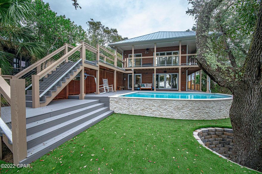 Located right in the heart of the St. Andrews Historic District, breathtaking views and gorgeous sunsets await you... Coastal elegance best defines this beautiful waterfront home. This incredible bayfront retreat is nestled at the end of a gated driveway, surrounded by lush landscaping, with mature oaks that provide the sanctuary you've been searching for. This home features over 3,000 square feet of luxury with 4 bedrooms (two master bedrooms - one on first floor and the other on second floor overlooking the bay) along with 3.5 baths, plus a separate 2 bedroom - 2 bath bungalow for a total of 6 bedrooms and 5.5 baths. New heated pool with upgraded water feature jets and upgraded lighting system, surrounded by manufactured turf. Property wide high speed internet with Sonos media  systems throughout the house and outside entertainment areas. The Chef Inspired kitchen is the perfect place to gather with family and friends as you watch the dolphins play right from your family room! This home features everything you've ever desired... a hidden closet to the secondary kitchen prep area and Butlers Pantry with another dishwasher, sink where you will find the laundry room with second floor laundry shoot. Closed cell insulation & LED lights throughout, this energy efficient home's power bill averages less than $250 a month. The perfect house for the boating family... just minutes to the pass and Shell Island, the boat dock permit is in hand and is in progress to be built. Full RV 50 amp hookup with clean out. This is truly a must see to believe home!