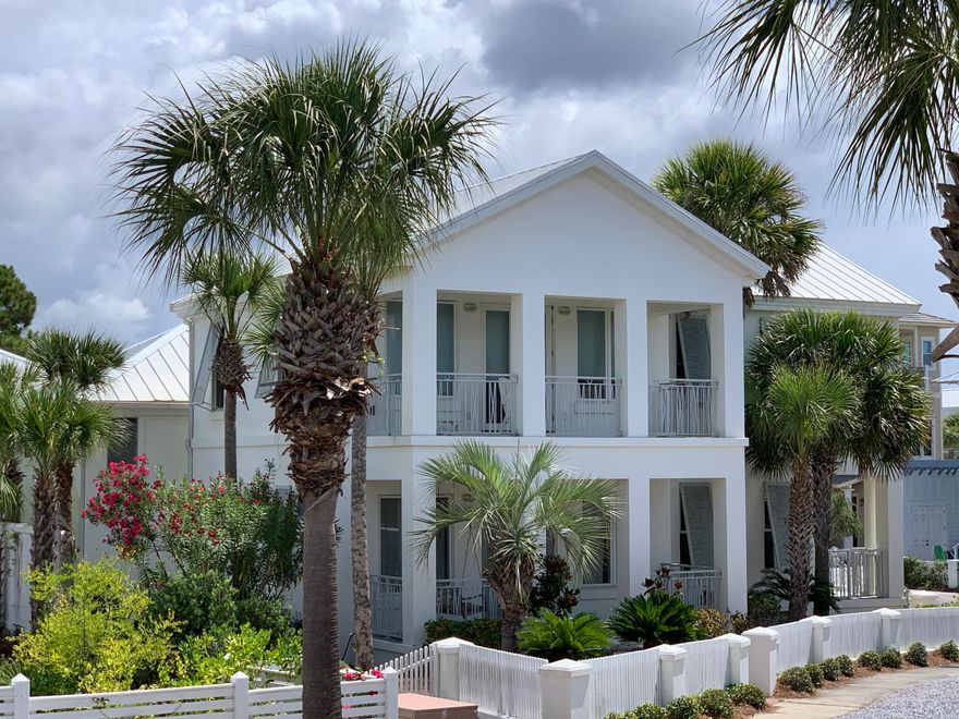 All CONCRETE Main house and guest house is wood framed. Beach Walkover is directly across the street. Steps to the Gulf!!  Main House has multiple covered porches for outside living. Views  of the Gulf from Master, Guest bedroom and Living room!!   This is a poured in place concrete MAIN house with beautiful hardwood stairway, extensive ceramic tile for easy living. Main house has 4 bedrooms 3 baths. The two story Guest House has 2 bedrooms, a Murphy bed and full size bath.  Huge corner lot by Sandyshore & Beachside Drive.Directly across from Beach walkover. Carillon Beach is a "jewel box" gated community with a private beach, 3 swimming pools, basketball court, tennis courts, children's playground, restaurants, spa, gym, and other businesses. 2 lakes,
8 private beach walkovers.
Special neighborhood you can actually live here full-time ore part-time. You will get to know your neighbors and there is  community functions throughout the year.