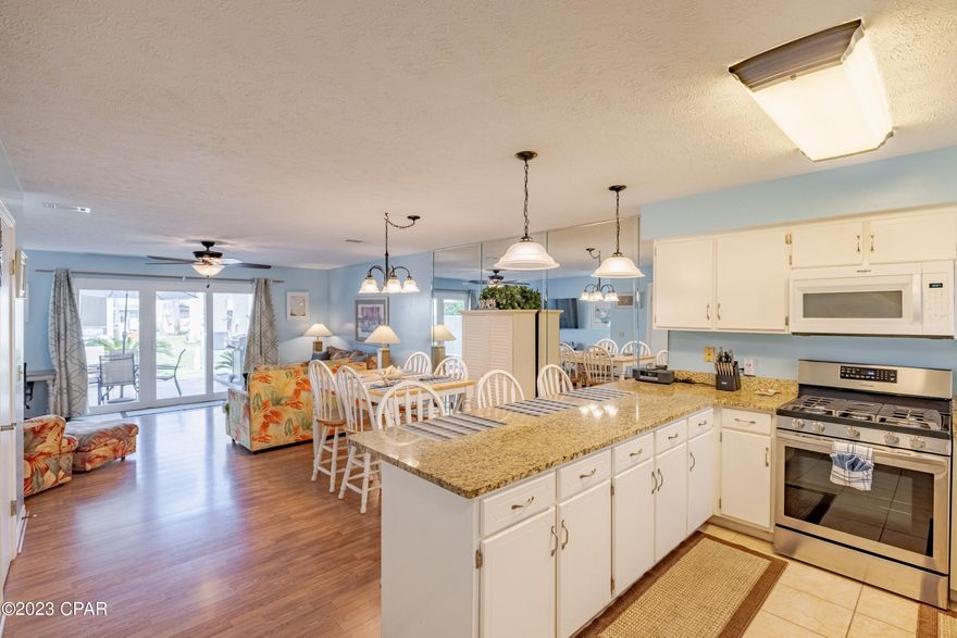 CURRENTLY UNDER CONTRACT, SELLER WILL CONSIDER BACKUP OFFERS. Looking for a great rental investment property, vacation or primary home? Look no further than this 2 bedroom, each with it's own full bathroom, townhome located in the highly desired, golf cart friendly Gulf Highlands Beach Resort in beautiful Panama City Beach! This fully furnished home comes equipped with new hurricane impact windows and sliding back glass door. You'll enjoy cooking meals in the kitchen that boasts granite countertops and stainless steel appliances (2021). The back patio area comes equipped with a grill and patio furniture perfect for an evening of entertaining or relaxing after you have spent the day at the beach or pool areas. Gulf Highlands Beach Resort has one of lowest HOA fees in the area that includes 11 pools (5 are heated), shuffleboard, tennis, mini golf, exercise room, playground, fishing, ground keeping, gated community, golf cart parking at gated beach access, exterior termite control, trash and wifi/cable. There is also a beachfront beachhouse cafe with restooms. This home offers a half bath downstairs along with an owner's closet for storing personal items, keyless entry on the front door and a smart thermostat. You will never have to worry about parking bc this home includes two designated parking spaces right in front of the home. This well maintained townhome has so much to offer.  Call soon to schedule a showing. Buyer must verify all details and info deemed important. Measurements are approximate.