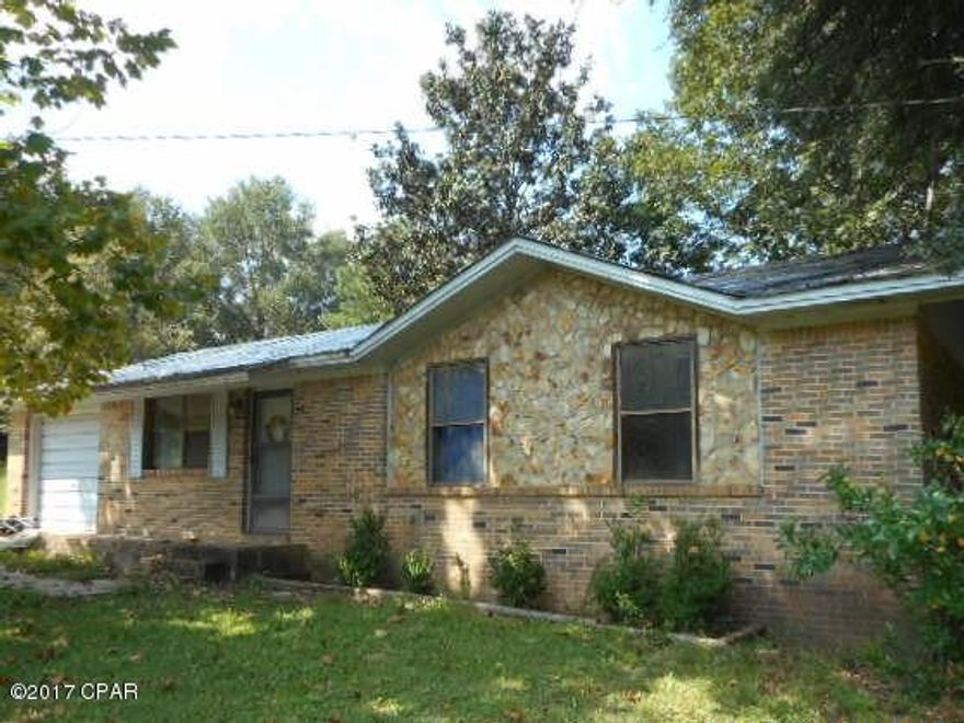 Brick home is REO located on one acre in country setting north of Hwy 2. The home is three bedroom, 1.5 bath, with HVAC. No appliances. There is a small utility shed and a dog pen in back yard. One car attached carport. Property is being sold as is.  Home will not qualify for financing.  Cash only.  Needs roof work and window replaced. There is some fencing but not completely fenced.  Fronts paved road.  Private well and septic.
