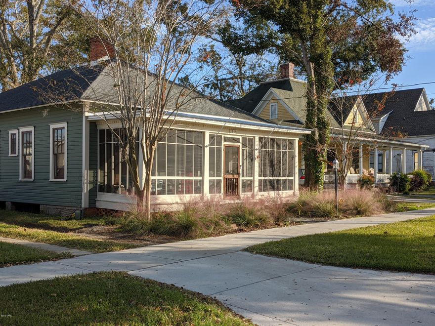 'CURRENTLY UNDER CONTRACT, SELLER ACCEPTING BACKUP OFFERS'  Charming Cottage located in the heart of town.  This house has been perfectly renovated with original heart pine floors, bead board paneling in several rooms, 3 fireplaces with a gas stove in living room, instant hot water heater, and lots of character.  It is a 2 bedroom, 1.5 bath, living room, dining room, kitchen, large laundry, front screened porch and back covered porch.  The kitchen has been totally updated with a farmhouse sink, butcher block countertops, gas stove and all updated appliances. The master bath has a large tiled shower & clawfoot tub and 2 separate vanities.  There is a large detached storage garage with new roof currently being installed. You will love the