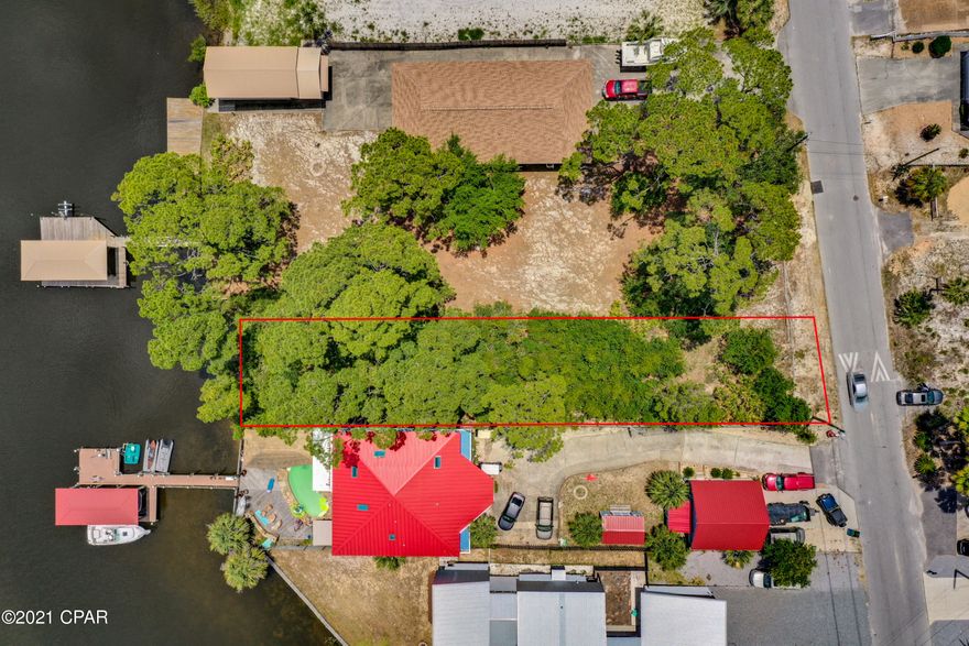 CURRENTLY UNDER CONTRACT, SELLER ACCEPTING BACKUP OFFERS Have you been looking for the perfect property with deep water access to build  your dream home? Check out this great property located on the Lagoon and within walking distance to Beach Access 21 (0.4 miles = 8 minute walk) and Rick Seltzer Park (0.7 miles = 15 minute walk or 3 minute drive).  Build your dream home with a boat dock and lift and enjoy fishing in the bay or gulf without the hassle of having to launch your boat and all the benefits of living on the beach. Enjoy 4th of July and fireworks from the water or hop over to Shell Island and enjoy a day on the island with all the locals. This prime piece of property is perfect for boaters and fishermen. Don't miss this GREAT opportunity to live your best Salt Life.