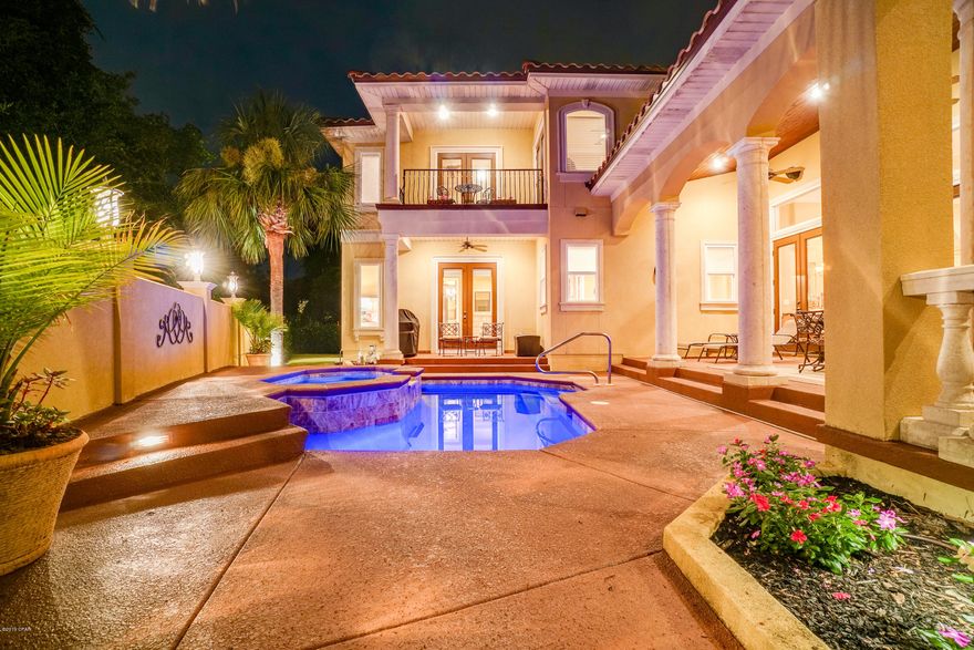 5203 Finisterre Dr. combines the taste of luxury, quality design and construction, with pure beauty. This custom Mediterranean home, located in the renowned development of Finisterre, is unlike any other home in Bay County. This gated waterfront community is secluded, yet only minutes to some of the best dining, boating, fishing and activities in Panama City Beach. The moment you pull up to your new home you'll immediately notice the attention to detail in the entry, pool and brick paver courtyard. As you walk inside, you'll fall in love even more. Not only are the upgrades endless, all the furniture stays!! Just a few of the amazing features include 8 ft interior doors, 2 car-garage plus golf cart area, true master suite with over-sized closet, surround sound throughout, heated pool and hot tub, outdoor shower and lush tropical landscaping. The community dock offers easy access for boating, and the tennis/basketball courts are great activities for the friends and family. This is one you have to see to truly appreciate everything it has to offer, so call us today!