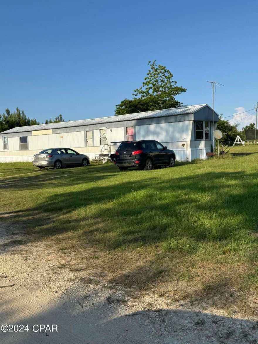 Single wide Mobile Home 3/2 with an old homestead home on 2+/- acres.This listing has a total of 2+/- acres with with 1+/- acre being cut out of the adjacent property to include the well. Property is on the corner of Kynesville Rd and Holley Timber.
