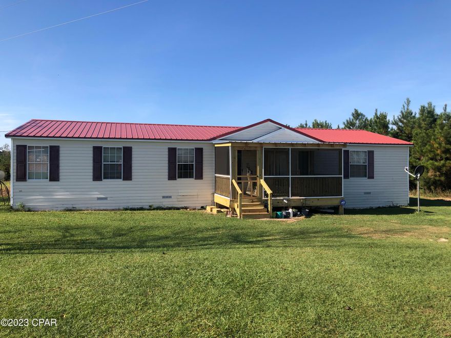 CURRENTLY UNDER CONTRACT, SELLER WILL CONSIDER BACKUP OFFERS. -  Nice 8.5 acres mol with a 3/2 Double Wide with split bedroom design. Fire place for cozy evenings, Newer Central heat and air unit. New roof in 2019, all this with paved road and County graded road frontage. Excellent garden area. Near 231 and I-10 for convenience. About 45 min to Panama City's 23rd street area. So close to the beaches and excellent hunting and fishing in the area and horses and livestock okay!