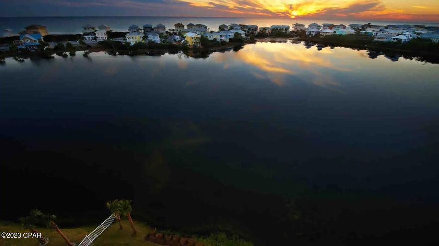 Here is your chance to have the 30-A life style without the cost of 30-A.  Gorgeous sunset views  off your balcony with the protection of al lake Carillon.  One king bed and a pull out cabinet bed. So you can sleep 4 in this cozy condo.  Nice white sofa and two new tvs.  Kitchen with granite  and a bar sitting area.   A neighbourhood with kayaking  expansive beaches, biking,  tennis and basketball courts. Open green spaces. Even Carillon bells and a chapel. This ideal setting is enhance with a cute as a button condo.  This is a wonderful unit for a couple or a great rental opportunity. Almost a mile of beach front gated for Carillon residents to enjoy. You get to decide.  Seller is a real estate agent. I don't want to part with this but we have kids in college.