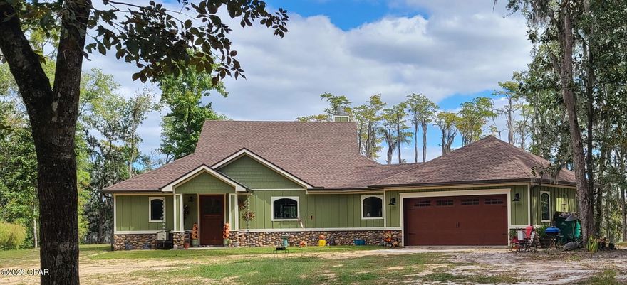 Custom, ICF CONSTRUCTION, WATERFRONT home with acreage located in Paradise Lakes, Washington County Florida- 2BR/2 Bath -1848 sq feet/3030 sq ft under roof. 3.57 acres+/- of Dunford Lake water frontage....There are 4 contiguous lots at this homesite, but the GARDEN lot has has no structure could easily be SOLD as a vacant, buildable lot...Exterior of Home- CRAFTSMAN look and feel with 36 inch river rock stone border to include columns of front porch with Hardi brand board & batten around the full exterior, Roof deck(attic) sprayed with 6 inches of open cell spray foam- Andersen A- series, picture style windows cased in  oak, windows wet flashed with Prosoco wet flashing, Andersen A- series doors with multi point locks cased in oak, Larson Mahogany 42 inch solid wood front door, 3ft wood sea wall, Haas 664 Mahogany Bi-directional grain, 6 pane garage door with arched windows and hurricane rated with handles and hinges-6 inch seamless gutters around perimeter of house, huge screened in back porch 10x50 which stretched full length of the home (waterfront)...Geo- technical boring done on site to insure suitable, stable ground for the Construction of the home..Interior of Home- Living Room features a huge, Stone accent, Wood burning fireplace with Gas log lighter, built in oversize book cases, 6x8 ft picture window, access to back porch, open and spacious Kitchen features Z line appliances to include 7 burner gas cooktop, double ovens, 45'' single bowl stainless z line sink, and a drawer style microwave, Zephyr flush-mount exhaust hood, Frigidaire Gallery 29 cu ft refrigerator, built in custom cabinets, oversized 6x9 Quartzite Island, open and spacious Guest Bath features skirted Kohler soaker tub, curb less, walk in shower and features Schluter system waterproofing membrane and floor pans,, double vanities with Kohler undermount, oversized sinks, and Kohler ride height toilet, ceiling fan (Fandelier) Guest bedroom-features French door entry to back porch, waterfront view Master Bedroom- features French door entry to back porch, waterfront view Master Bath-features curb less, Walk in shower with custom stonework and features Schluter system waterproofing membrane and floor pans, double vanities with Kohler undermount, oversized sinks, and Kohler ride height toilet, oversized dressing counter with chair, linen closet, ceiling fan Laundry/mud room- oversized canning pantry and mechanical closet located in this room, built in mop/hand sink, hanging space for laundry, built in storage cabinets to include a day bench Extras and upgrades-Custom reclaimed oak engineered wood flooring 8'' wide planks, Custom trim work throughout house, Interior doors are 8' solid wood doors, Cypress tongue & groove ceilings, custom cabinetry throughout the home, 10 foot ceilings, oversized canning pantry, Granite and Quartzite counter tops throughout, HUGE Garden- 60x 120 - soil tested twice a year, blueberry bushes, pear trees, peach trees, blackberry trellis, orange trees, lemon tree, and muscadine arbor.- electric fence Pole barn- fully permitted 24x36 12' eaves pole barn residential concrete slab, upgraded 26 gauge metal roof/walls, fully wired to include 30amp outlet barn has been sprayed with closed cell insulation roof/walls also has 2 10' wind rated roll up doors...Extra Features - 22 KW Generac whole house generator with transfer switch, deep well with water filter system and water softener system, 250-gallon Propane tank, RV parking access spot with ramp